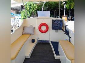 Interior view of a boat's helm and seating area, featuring a cozy cushion and a life ring — perfect for relaxing while cruising.