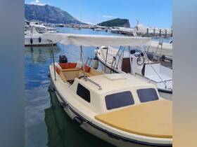A charming boat docked in a marina, showcasing its inviting seating area and serene surroundings — perfect for leisurely outings on the water.