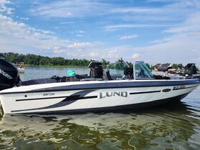 A sleek Lund fishing boat docked on calm waters, showcasing its modern design and features — perfect for a day of fishing or leisure on the lake.