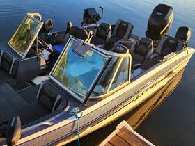 Interior view of a well-equipped boat showcasing comfortable seating and a modern helm, perfect for fishing or leisure outings.