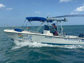 A fishing boat named 'Jossi Tours' navigates the open waters, showcasing an exciting day on the sea.
