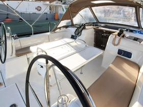 An inviting view of the interior helm area of a boat, featuring comfortable seating and a well-equipped console, perfect for navigating the waters.
