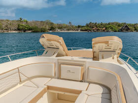 A spacious and elegantly designed seating area inside a boat, perfect for relaxing while enjoying the scenic views of the surrounding waters.
