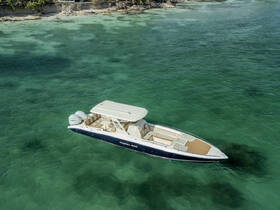 A stunning aerial view of a sleek speedboat cruising through clear turquoise waters, perfect for adventurous outings or island hopping.