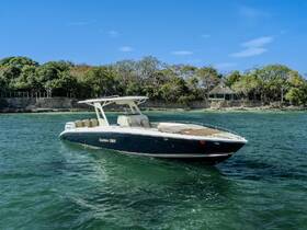 A sleek speedboat named Capitán 326 glides through clear waters, showcasing its elegant design against a lush, tropical backdrop.