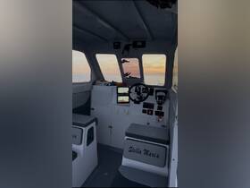 Interior view of the helm of the 'Stella Maria' boat, showcasing the control console and seating area, perfect for navigating the open waters.