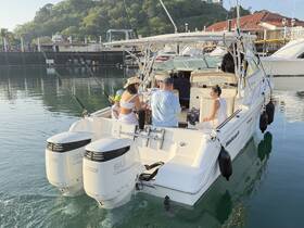 A group of friends enjoys a fishing trip on a well-equipped boat, capturing the essence of a fun day on the water.