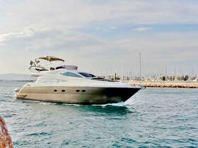 A sleek yacht glides through the water, showcasing its elegant design against a backdrop of a marina — perfect for luxury cruising and charters.