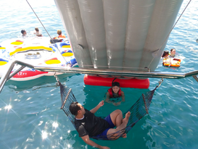 A fun-filled day on the water with friends enjoying a floating mat and swimming — perfect for summer adventures and family outings.
