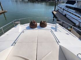 A cozy lounge area on the front deck of a yacht, featuring comfortable bean bags, perfect for relaxing while enjoying the waterfront views.