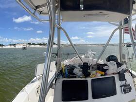 View of the helm area inside a boat, showcasing the console and equipment, perfect for navigating the waters.