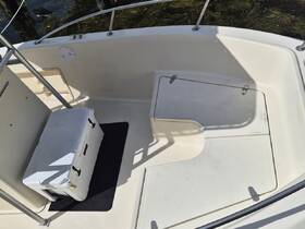 Interior view of a boat's helm area featuring a cooler, showcasing a clean and functional space ideal for relaxation and navigation.