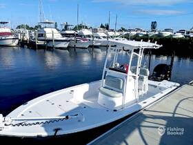 A sleek center console boat docked at the marina, showcasing its modern design and spacious layout, perfect for fishing or leisure outings.