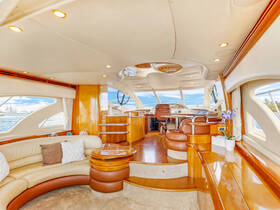 Interior view of a luxurious yacht cabin featuring comfortable seating and a well-equipped helm, perfect for relaxing or navigating the waters.
