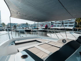 A view of the comfortable seating area inside a boat, showcasing a relaxing space perfect for lounging while docked at a marina.