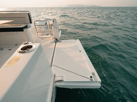 A close-up view of a sleek boat's exterior, showcasing its clean lines and modern design as it glides through the water.
