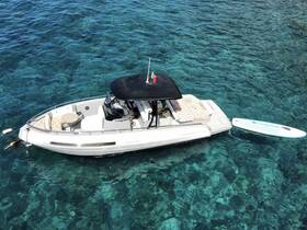Aerial view of a sleek speedboat anchored in crystal-clear waters, showcasing its stylish design and inviting seating area — perfect for a day of adventure on the water.