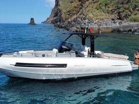 A stylish boat anchored near a stunning coastline, with a guest enjoying the sun and taking photos — perfect for a relaxing day on the water.