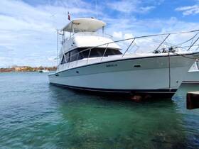 A sleek yacht named 'MARCELLE' docked in clear waters, showcasing its elegant design and inviting atmosphere for boating adventures.