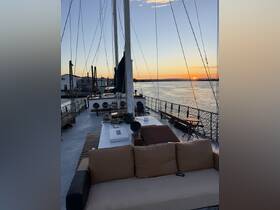 A cozy seating area on a boat's deck, perfect for enjoying sunset views over the water. Ideal for relaxing and socializing during a cruise.