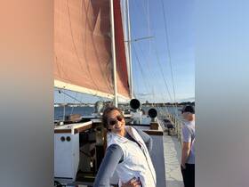 A joyful moment aboard a sailing vessel, capturing the excitement of a day on the water with friends.