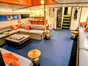 A cozy lounge area inside a boat featuring comfortable seating and stylish decor, perfect for relaxing during a maritime adventure.