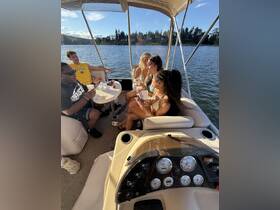 A lively group enjoys drinks and conversation inside a boat, capturing the essence of fun and relaxation on the water.