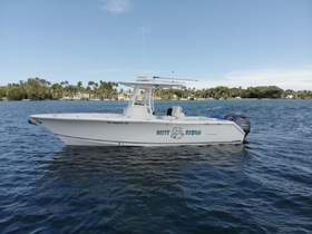 A sleek speedboat is showcased against a picturesque waterfront backdrop, perfect for adventurous outings on the water.