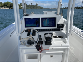 A detailed view of the helm and console of a boat, showcasing navigation equipment and controls, perfect for boating enthusiasts.