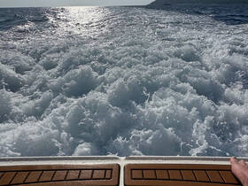 A stunning view of ocean waves and sunlight reflecting off the water, capturing the essence of a thrilling boat ride.