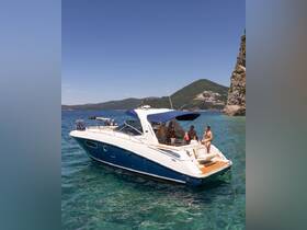 A lively group enjoys a sunny day aboard a boat, surrounded by clear waters and stunning coastline — perfect for summer adventures and relaxation.