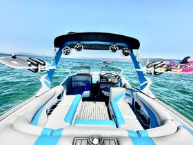 A stylish interior view of a boat showcasing comfortable seating and a modern helm, perfect for a day on the water.