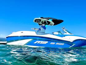 A sleek speedboat glides through clear waters, showcasing its vibrant design and sporty profile — perfect for thrilling water adventures.