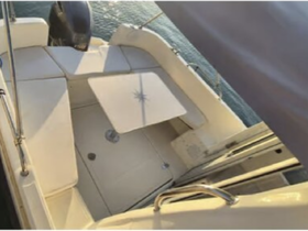 Interior view of a boat's seating area, showcasing a comfortable space ideal for relaxation while on the water.