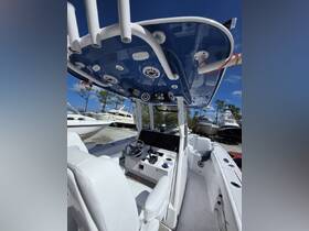 A detailed view of the helm area inside a boat, showcasing modern seating and control features, perfect for navigating the waters.