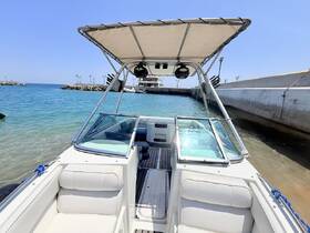 A view of the interior helm and seating area of a boat, showcasing a clean and spacious design ideal for comfortable cruising.