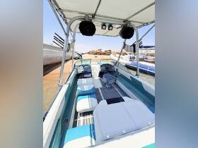 Interior view of a well-equipped boat featuring comfortable seating and a modern helm, perfect for a day on the water.