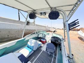 Interior view of a stylish boat helm featuring comfortable seating and modern controls, perfect for a day on the water.