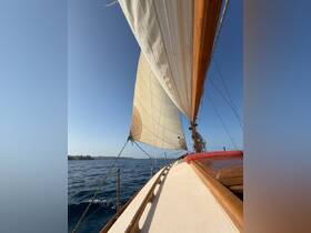 A stunning view of a sailboat's sails against a clear blue sky, showcasing the beauty of sailing on open waters.