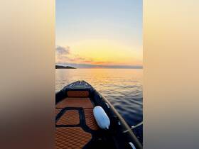 A serene view from the deck of a boat at sunset, showcasing calm waters and a beautiful horizon — perfect for peaceful evening cruises.