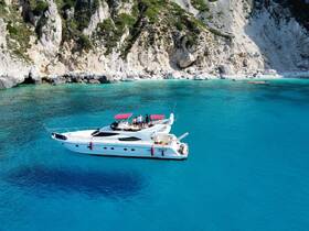 A group of friends enjoys a beautiful day aboard a yacht, surrounded by stunning turquoise waters and a picturesque coastline — perfect for memorable summer adventures.