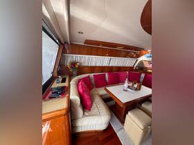 A cozy interior view of a yacht's lounge area featuring plush seating and elegant decor, perfect for relaxing during a boating trip.