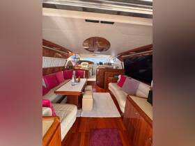 A beautifully designed interior of a yacht featuring comfortable seating and elegant decor, perfect for relaxing and entertaining while on the water.
