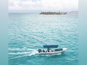 A sleek speedboat glides through the vibrant turquoise waters, showcasing the beauty of a tropical destination in the background.