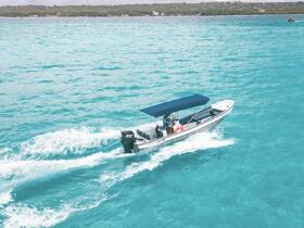 A sleek speedboat navigates through vibrant turquoise waters, showcasing the beauty of on-water adventures.