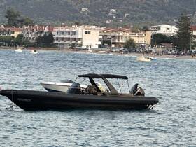 A sleek speedboat named 'Matrix' is anchored in calm waters, with a scenic backdrop of beachside buildings and lush hills, perfect for a day on the water.