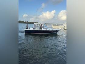 A group of anglers enjoys a fishing trip aboard the boat 'LADY HOO' in calm waters, showcasing the excitement of a day on the water.