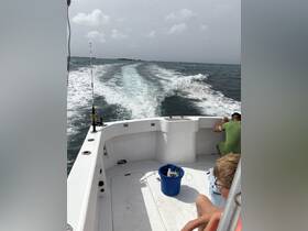 A group enjoys a fishing trip aboard a boat, with gear ready and the ocean waves in motion — perfect for adventure seekers on the water.