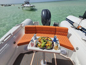 A beautifully arranged platter of fresh fruits and drinks on the deck of a boat, perfect for enjoying a relaxing day on the water.
