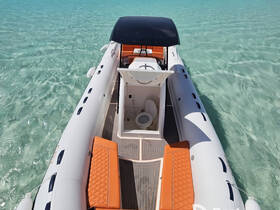 An interior view of a sleek inflatable boat showcasing comfortable seating and a compact cabin area, perfect for day trips on the water.